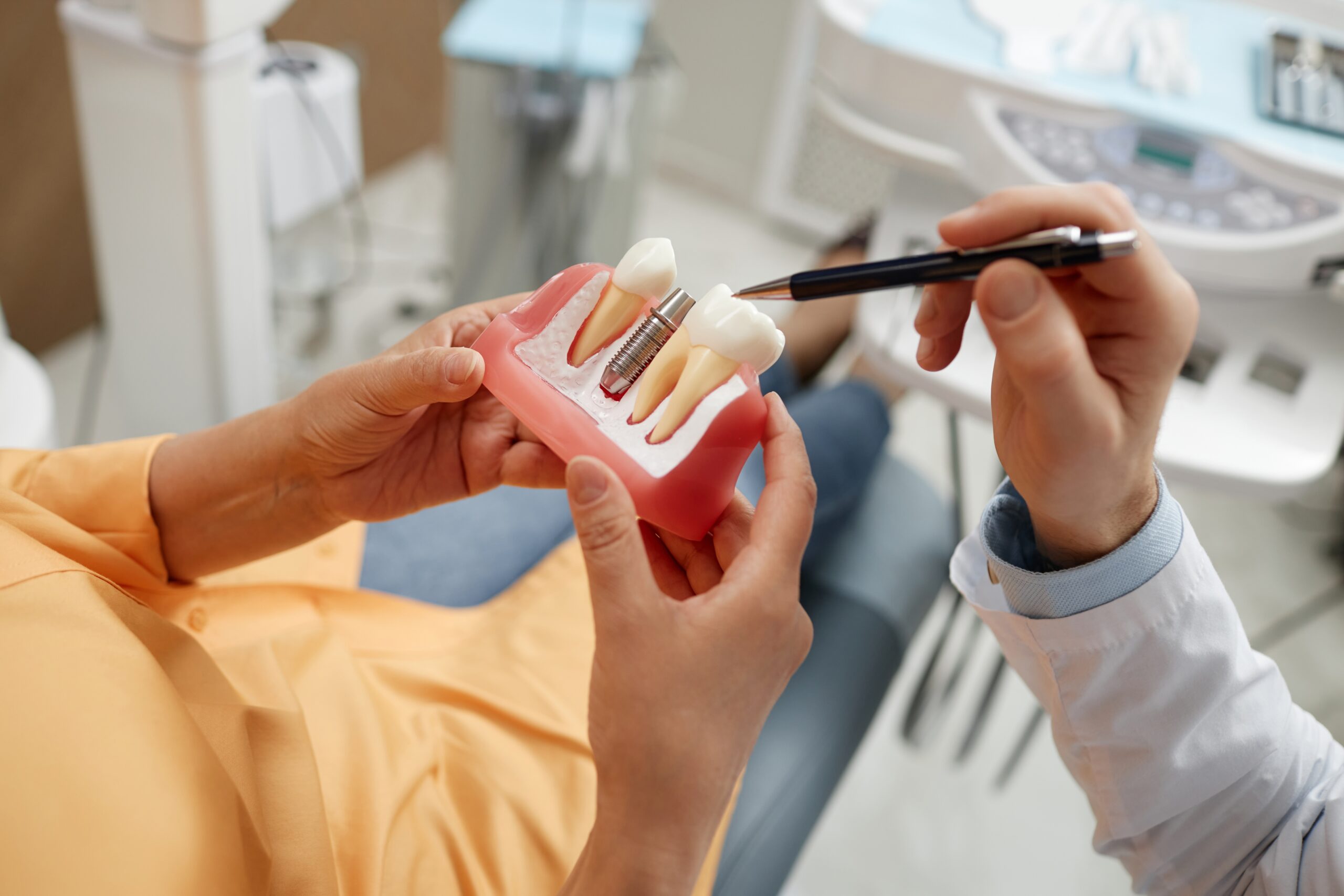 Periodontist discussing implant options with a patient to reduce the risk of periodontal disease.